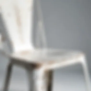 Close-up of distressed white metal chair showcasing detailed design