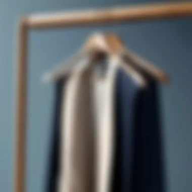 Elegant Wooden Garment Rack Close-up view of a wooden garment rack with neatly hung clothing.