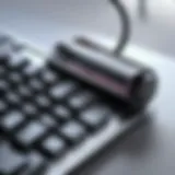 A close-up view of a compact keyboard vacuum cleaner in action, efficiently removing debris.